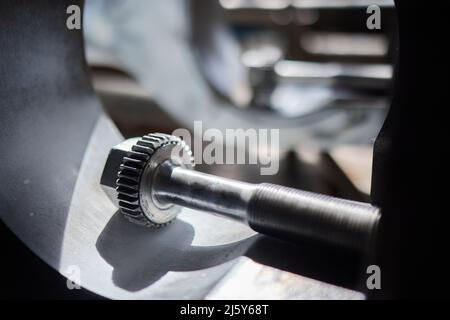 Close up of the CNC lathe jaw clamping raw material steel rod .Steel Cylinder part after turning process. Hi-precision CNC machining concept.Raw mater Stock Photo