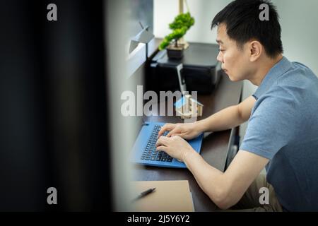 Male architect working at laptop in office Stock Photo