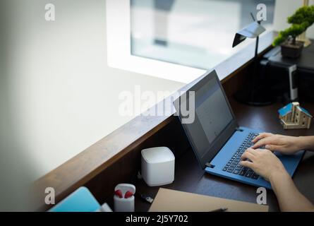 Hands of man typing at laptop in office Stock Photo