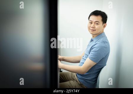 Portrait smiling businessman in office doorway Stock Photo