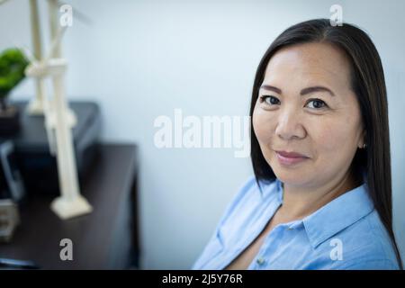 Portrait smiling female engineer in office Stock Photo