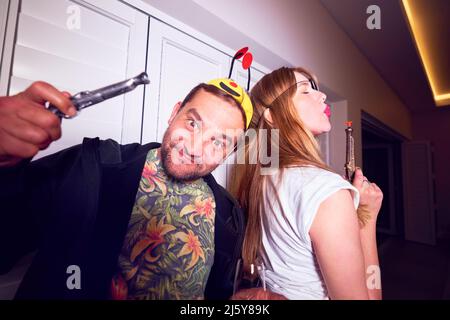 Portrait playful couple in costumes Stock Photo