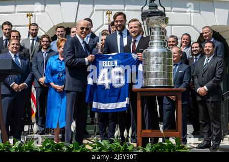 Washington, United States Of America. 25th Apr, 2022. Washington, United States of America. 25 April, 2022. U.S President Joe Biden holds up a team jersey given him by Tampa Bay Lightning alternative captain Victor Hedman and captain Steven Stamkos during an event to celebrate the Tampa Bay Lightning 2020 and 2021 Stanley Cup championships on the South Lawn of the White House, April 25, 2022 in Washington, DC Credit: Adam Schultz/White House Photo/Alamy Live News Stock Photo