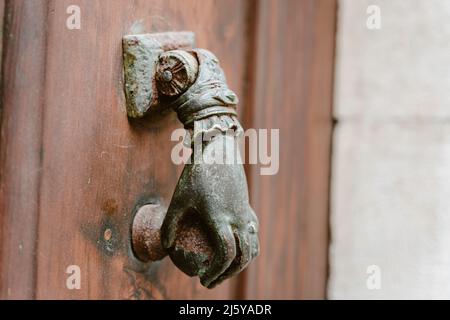 Hand shaped door knocker in France Stock Photo