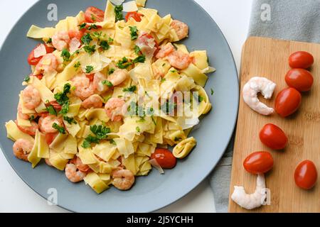 Pasta with shrimps with butter and cherry tomato Stock Photo