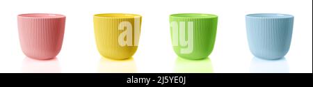 Empty colorful flower pots isolated on a white background. Set of vertical striped planters. Multicolored plastic pots for indoor plants. Stock Photo