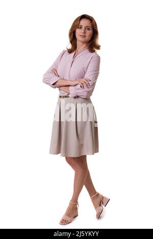 Full length young business woman standing with crossed arms isolated on white background. Stock Photo