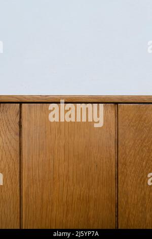 a white wall lined with wooden planks Stock Photo