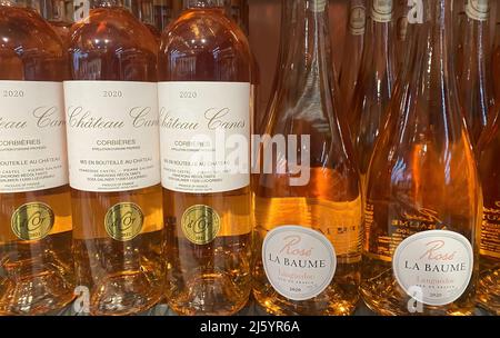 Viersen, Germany - April 9. 2022: View on bottles french rose wine in shelf of german supermarket Stock Photo