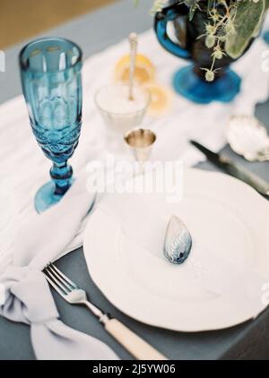 Dining table closeup. Blue and white colors. Wedding dinner at the beach. Catering table setting Stock Photo