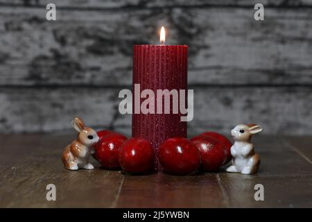 Festive composition with Easter eggs and candles. Stock Photo