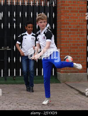 Young Fulham fans play football outside the ground before the Sky Bet Championship match at Craven Cottage, London. Picture date: Tuesday April 26, 2022. Stock Photo