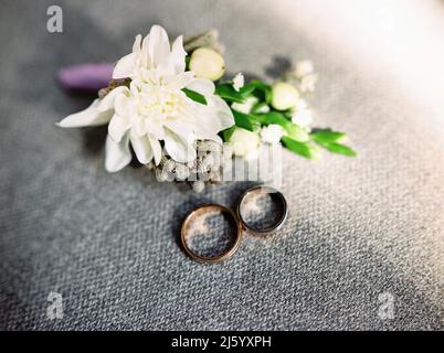 Wine glasses, wedding rings bedding of grass and moss on white table next  to bohemian tipi arch decorated in boho style with flowers and candles and  Stock Photo - Alamy