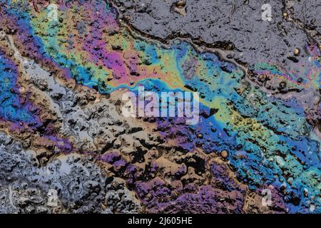 Oil sheen originating from a truck's hydraulic fluid on asphalt in central Michigan, USA Stock Photo