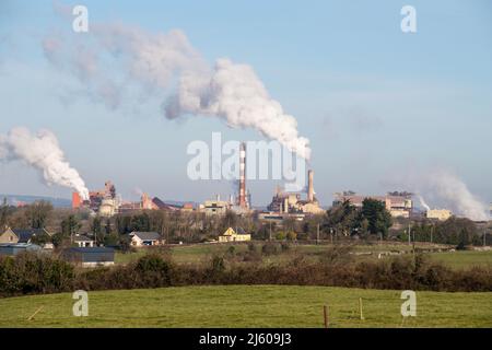 Large factory with smoky chimneys, sky covered with smoke Stock Photo