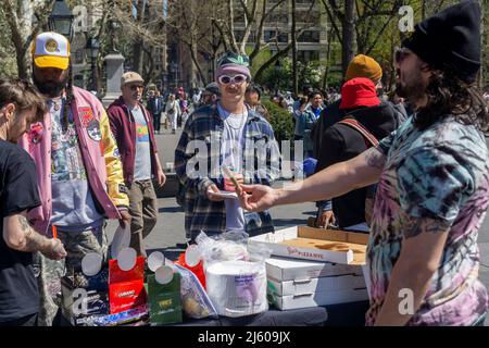 Vibes gives away rolling papers and free pizza. ÒPotrepreneursÓ flock to Washington Square Park in New York on Wednesday, April 20, 2022 to sell their marijuana related wares and to celebrate Ò4/20Ó, the unofficial cannabis holiday. New York legalized marijuana in 2021. (© Richard B. Levine) Stock Photo