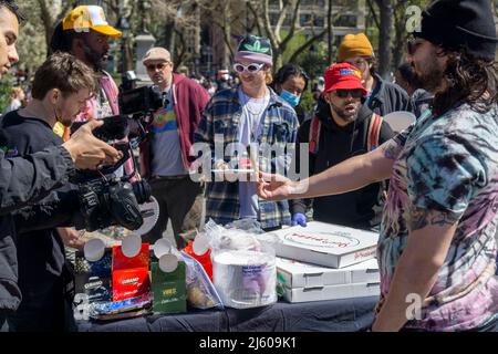 Vibes gives away rolling papers and free pizza. ÒPotrepreneursÓ flock to Washington Square Park in New York on Wednesday, April 20, 2022 to sell their marijuana related wares and to celebrate Ò4/20Ó, the unofficial cannabis holiday. New York legalized marijuana in 2021. (© Richard B. Levine) Stock Photo