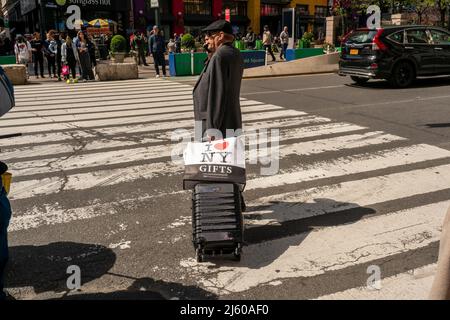 Traveler waits to cross Sixth Avenue in Herald Square in New York on Saturday, April 23, 2022. ( © Richard B. Levine) Stock Photo
