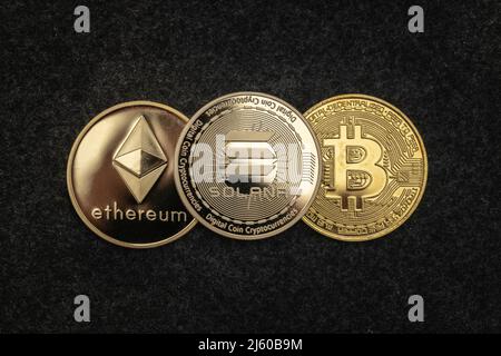 Solana SOL, Ethereum ETH, and Bitcoin BTC cryptocurrency physical coin. Stock Photo