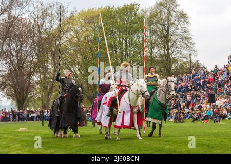 Knights wearing armour hold jousting poles whilst riding horses at a medieval re-enactment. Stock Photo