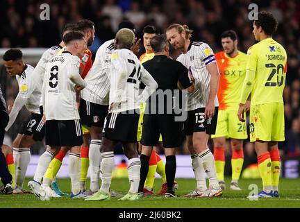 Fulham's Tim Ream (13) remonstrates with referee Keith Stroud after Nottingham Forest's Steve Cook goes to ground during the Sky Bet Championship match at Craven Cottage, London. Picture date: Tuesday April 26, 2022. Stock Photo