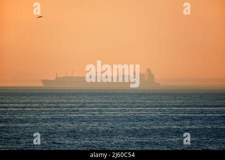 LNG vessel silhouette in polish harbour of Świnoujście Stock Photo