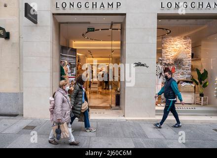 Shoppers walk past the French luxury fashion brand Longchamp store