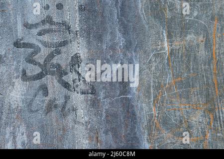 Old multi colored cement wall scribble markings, cracks, and crevices Stock Photo