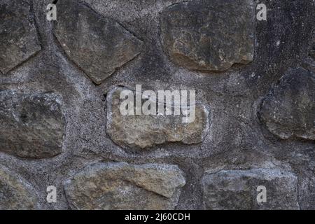 Old gray stone and mortar wall background texture Stock Photo