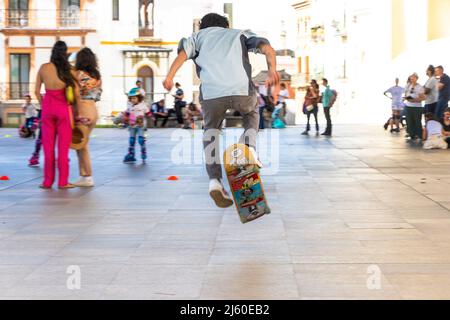boy doing skateboard tricks in Seville Sevilla spain under las Setas de sevilla Stock Photo