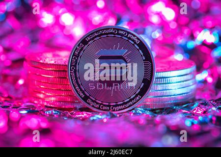 Solana SOL cryptocurrency physical coin, abstract background. Stock Photo