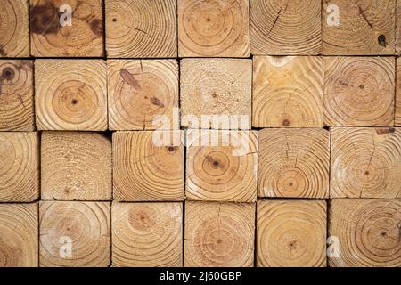 End profile view of stacked 4-inch x 4-inch wood timber, showing the rough edge and wood grain. Stock Photo