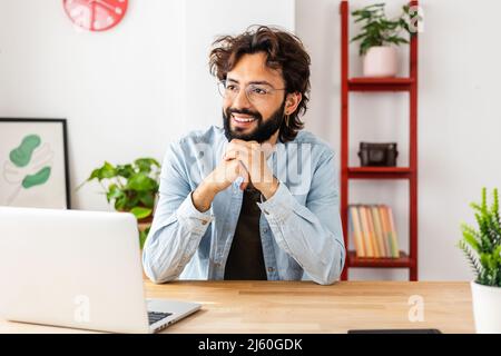Smiling businessman looking away daydreaming while on a break from work. Stock Photo