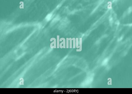 Caustic effect light refraction on mint wall overlay photo mockup, blurred sun rays refracting through prism with shadow. Abstract natural light Stock Photo