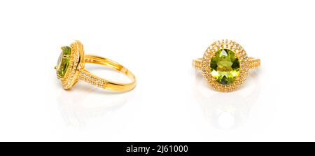 Peridot and Diamond Jewel or gems ring on white background with reflection. Collection of natural gemstones accessories. Studio shot Stock Photo