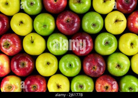 background of colored apples forming diagonal rows. Taking an overhead photo. Stock Photo