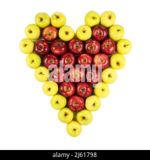 Isolated red and yellow apples forming a heart on white background. Stock Photo