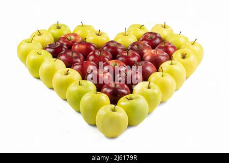 Isolated red and yellow apples forming a heart on white background. Stock Photo