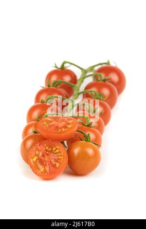 Group of red cherry tomato on branch, many units, isolated on white background. Fruits and vegetables background, copy space. Stock Photo