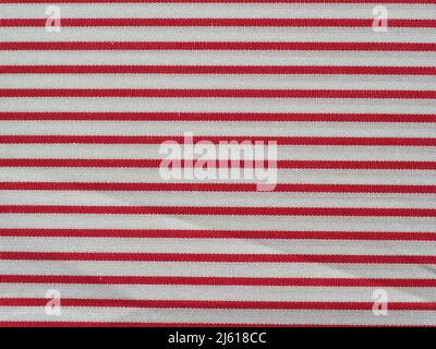 striped red and white cotton fabric texture useful as a background Stock Photo