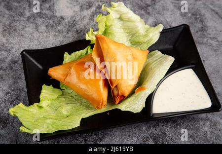 Veg Samosa - is a crispy and spicy Indian triangle shaped snack. Stock Photo