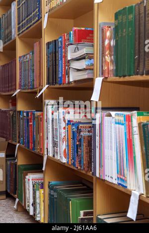 Chapaevsk, Samara region, Russia - December 24, 2020: Books on a shelf in the library. Selective focus Stock Photo