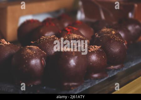 Cheese candies in chocolate coating on counter. Stock Photo
