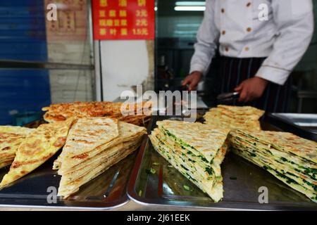 Cong you bing is a traditional Chinese scallion oil pancake / flatbread. Nanjing, China. Stock Photo