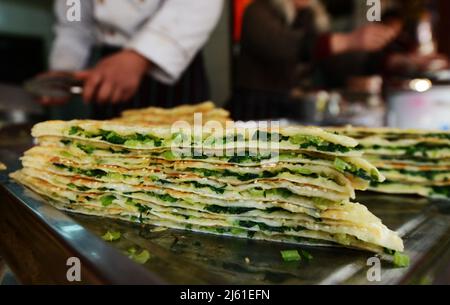 Cong you bing is a traditional Chinese scallion oil pancake / flatbread. Nanjing, China. Stock Photo