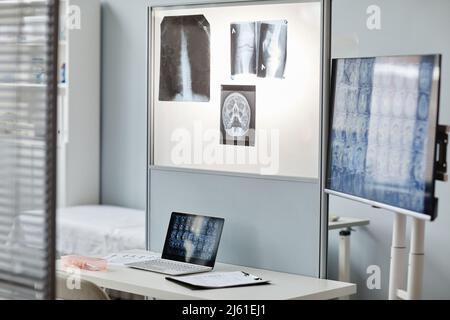 No people shot of modern radiologists office interior with laptop, screen, x-ray and tomography images Stock Photo