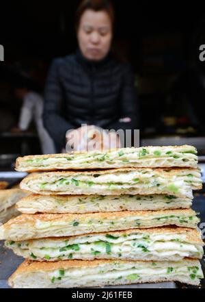 Cong you bing is a traditional Chinese scallion oil pancake / flatbread. Nanjing, China. Stock Photo