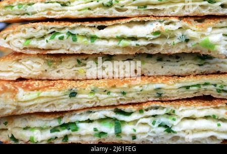 Cong you bing is a traditional Chinese scallion oil pancake / flatbread. Nanjing, China. Stock Photo