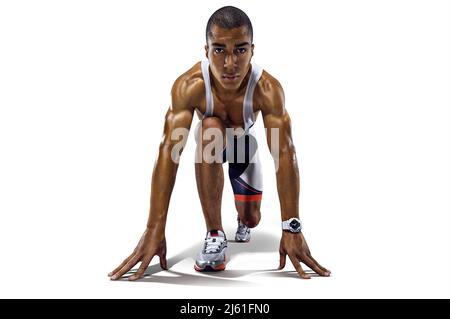 Athletic runner on the start. Sports background. Stock Photo