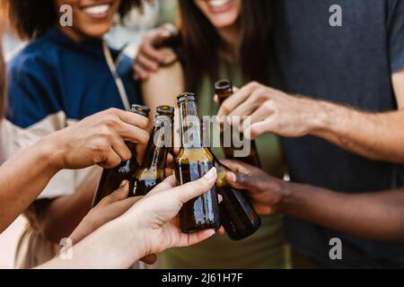 Multiracial friends cheering with beer at summer music party Stock Photo